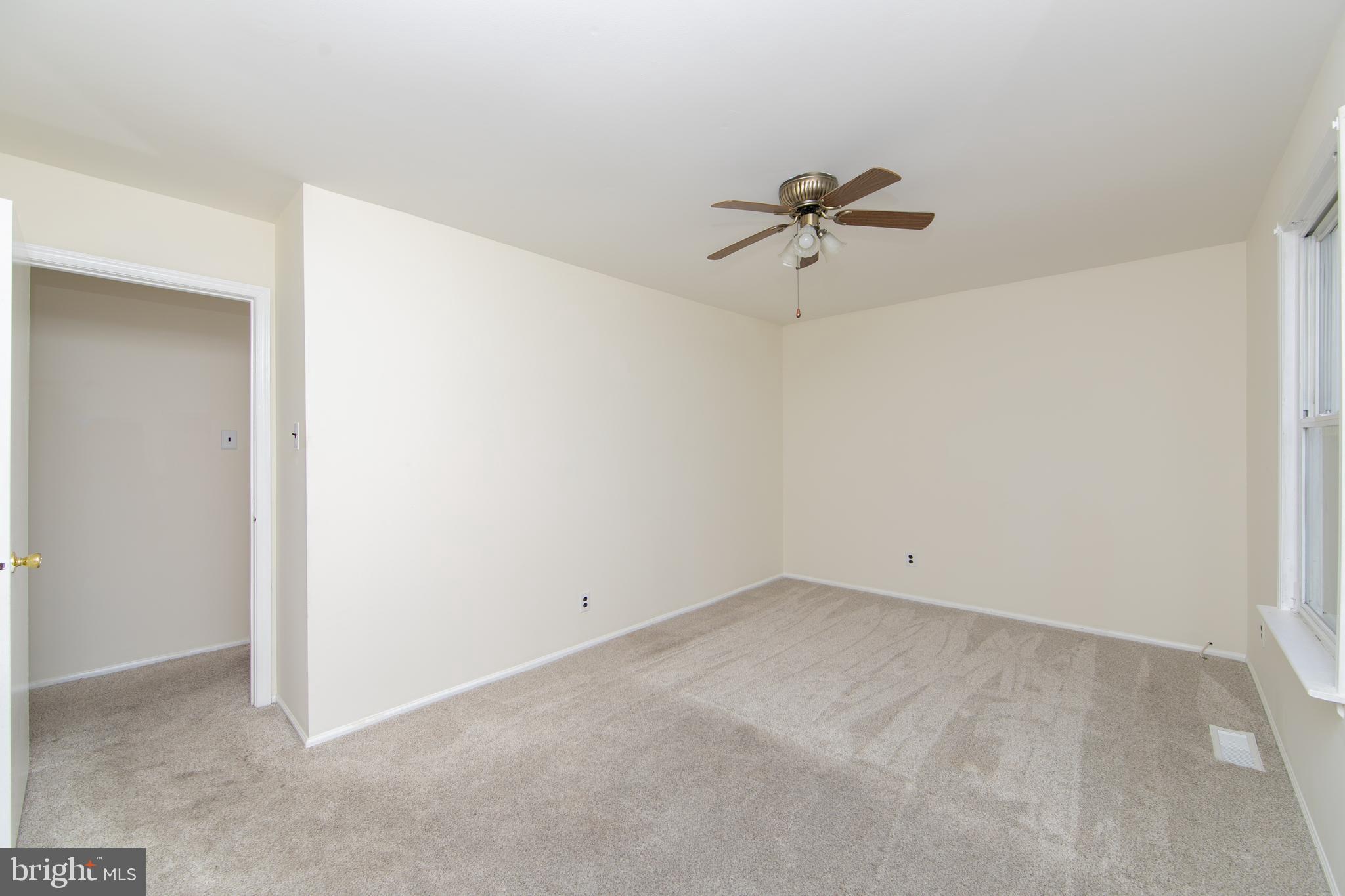 1042 Central Avenue Runnemede, NJ 08078 - Photo 18 of 36 an empty room with a ceiling fan and a window