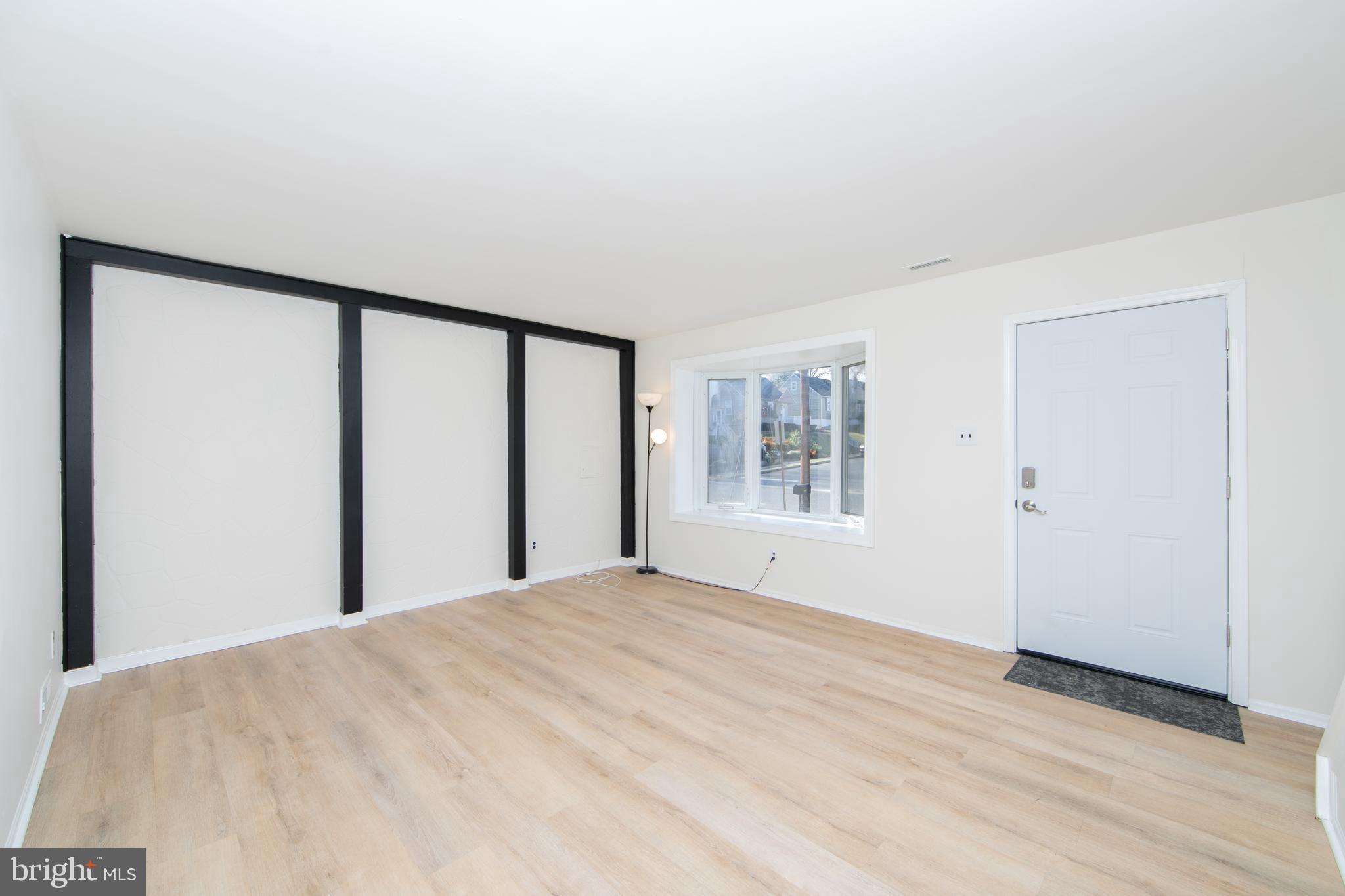 1042 Central Avenue Runnemede, NJ 08078 - Photo 5 of 36 a view of a big room with wooden floor and windows