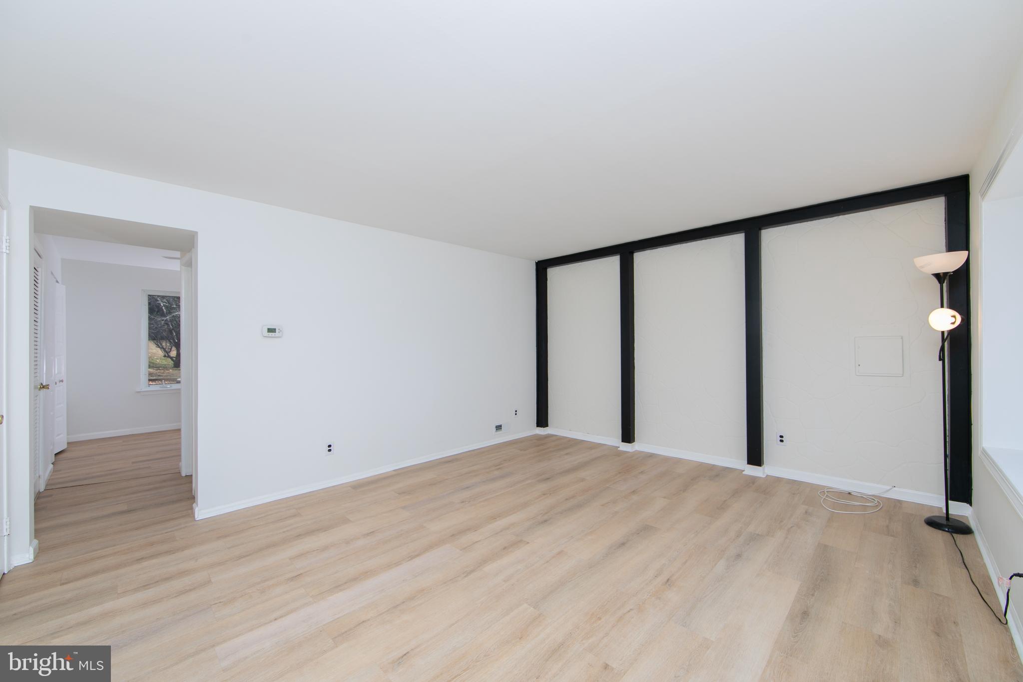 1042 Central Avenue Runnemede, NJ 08078 - Photo 7 of 36 a view of a big room with wooden floor and windows