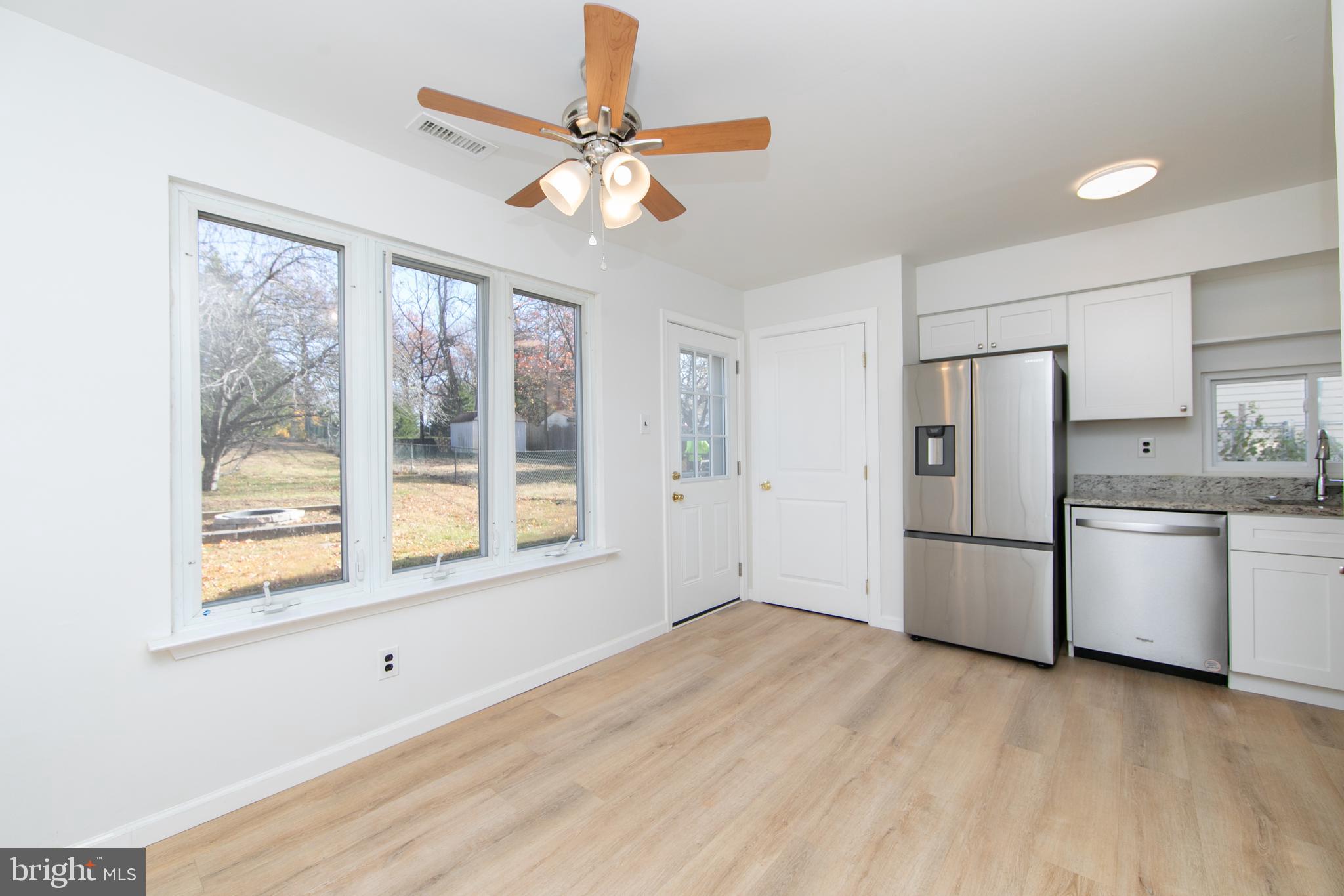 1042 Central Avenue Runnemede, NJ 08078 - Photo 10 of 36 a view of a kitchen with a stove cabinets a ceiling fan and wooden floor