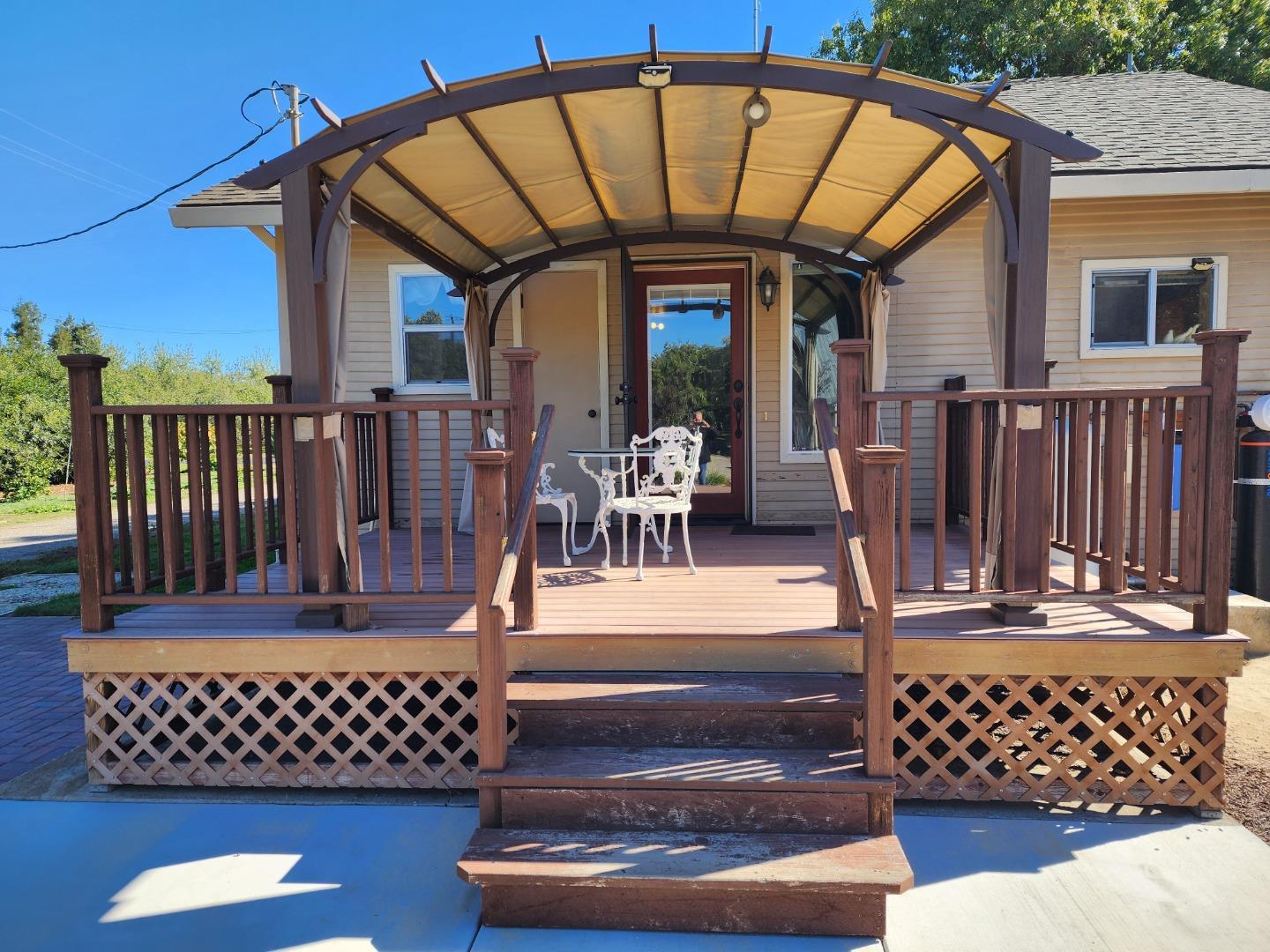 3719 North Hart Road Modesto, CA 95358 - Photo 25 of 43 a view of a chairs and table on the deck
