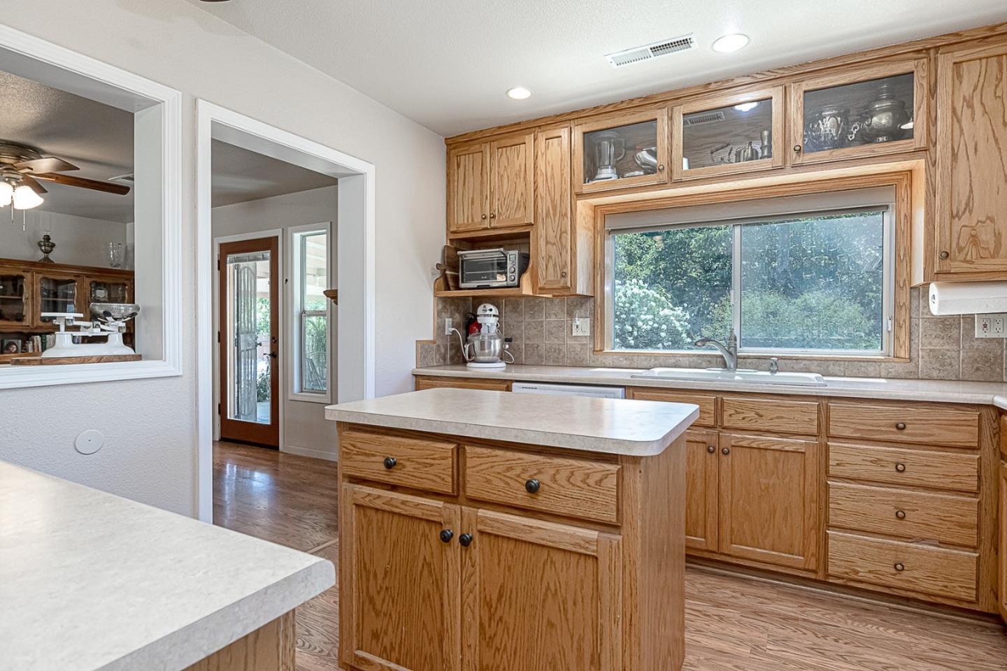 3719 North Hart Road Modesto, CA 95358 - Photo 7 of 43 a kitchen with stainless steel appliances granite countertop a sink and cabinets with wooden floor
