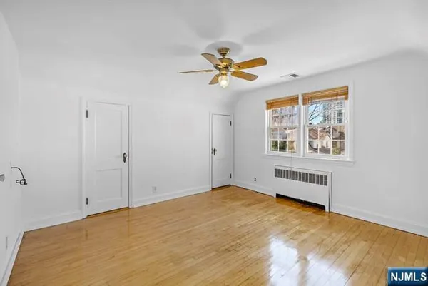a view of empty room with ceiling fan