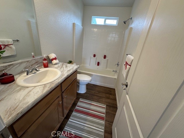 43601 East Florida Avenue, Unit 98 Hemet, CA 92544 - Photo 13 of 16 a bathroom with a sink a mirror and a toilet