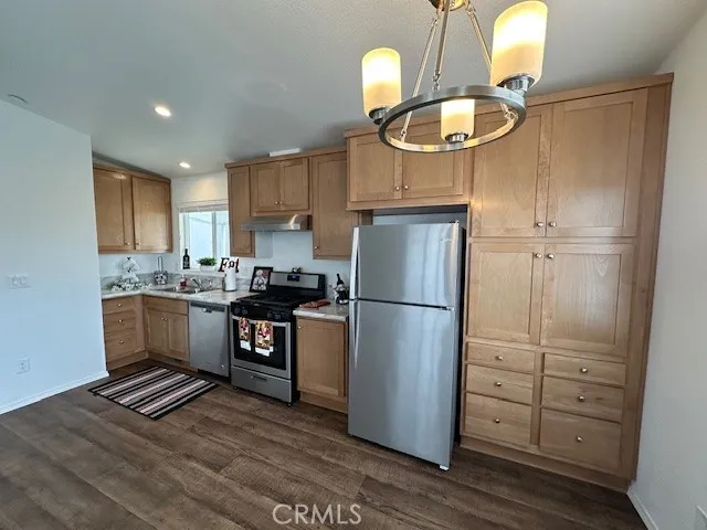 a kitchen with a refrigerator a sink and cabinets