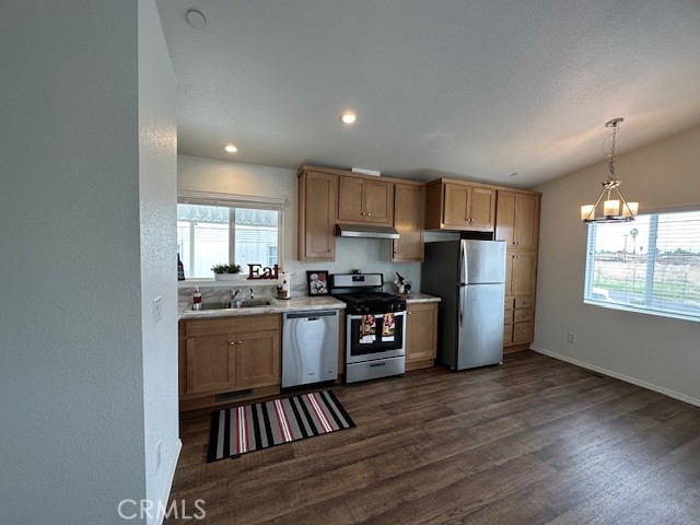 43601 East Florida Avenue, Unit 98 Hemet, CA 92544 - Photo 9 of 16 a kitchen with stainless steel appliances granite countertop a refrigerator stove a sink dishwasher and a oven with wooden floor