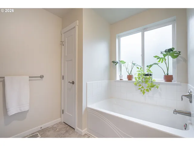 a white bath tub with a shower