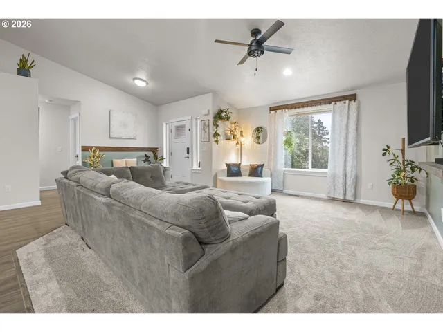a living room with furniture and a large window
