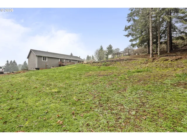 a backyard of a house with large trees