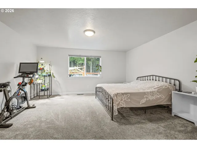 a spacious bedroom with a bed and a table