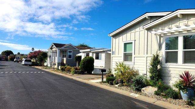a view of a house with sitting area and potted plants