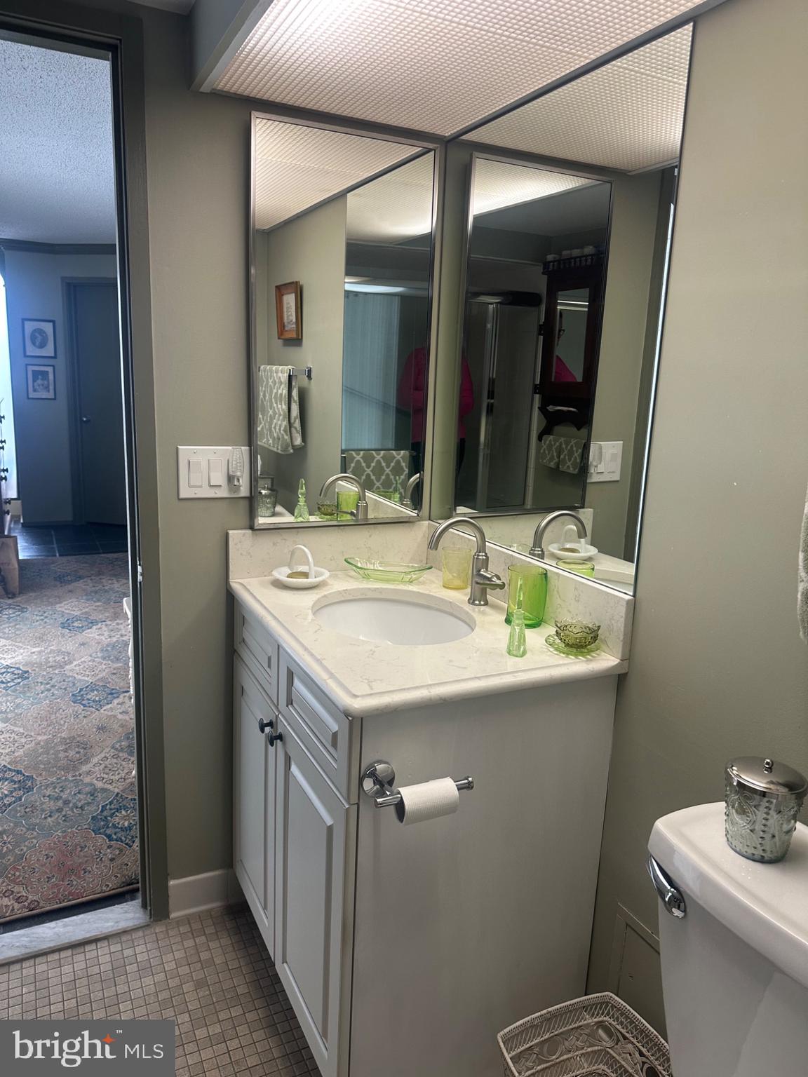 1 Markham Road, Unit 1D Princeton, NJ 08540 - Photo 20 of 55 a bathroom with a sink and mirror with toilet