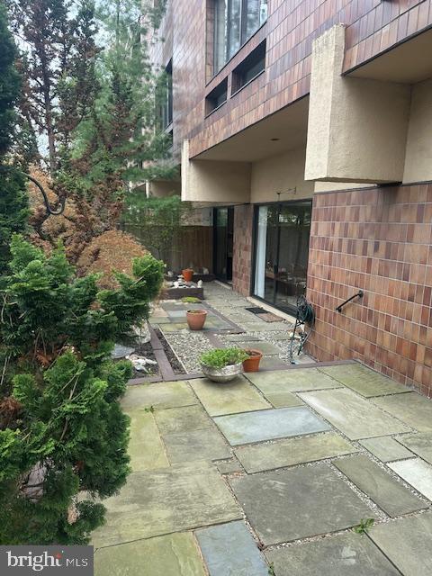1 Markham Road, Unit 1D Princeton, NJ 08540 - Photo 47 of 49 a view of a patio with table and chairs under an umbrella