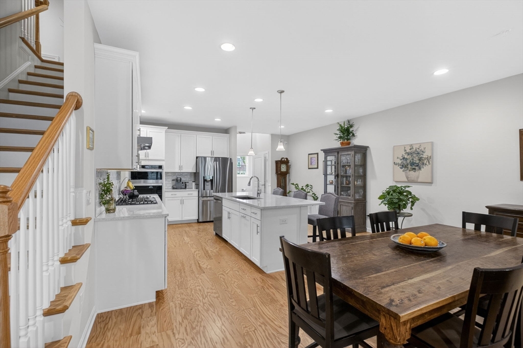 87 Shannon Way, Unit 86 Upton, MA 01568 - Photo 9 of 36 a view of kitchen with cabinets and wooden floor