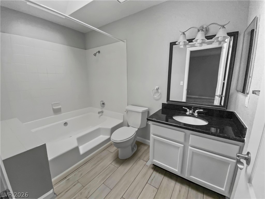 9325 West Desert Inn Road, Unit 278 Las Vegas, NV 89117 - Photo 8 of 17 Elegant dark granite counters complement the crisp white vanity in this serene bathroom space.