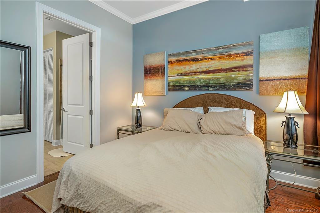 230 South Tryon Street, Unit 703 Charlotte, NC 28202 - Photo 11 of 22 a bedroom with a large bed and a large window