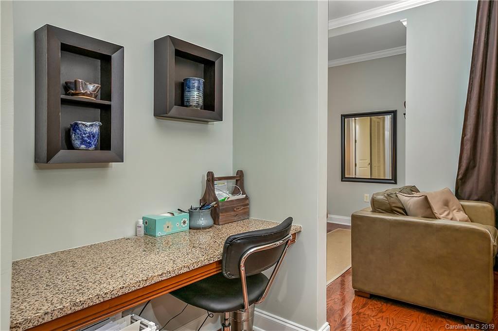 230 South Tryon Street, Unit 703 Charlotte, NC 28202 - Photo 9 of 22 a living room with furniture and a wooden floor