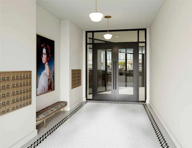 a view of a hallway with wooden floor and door