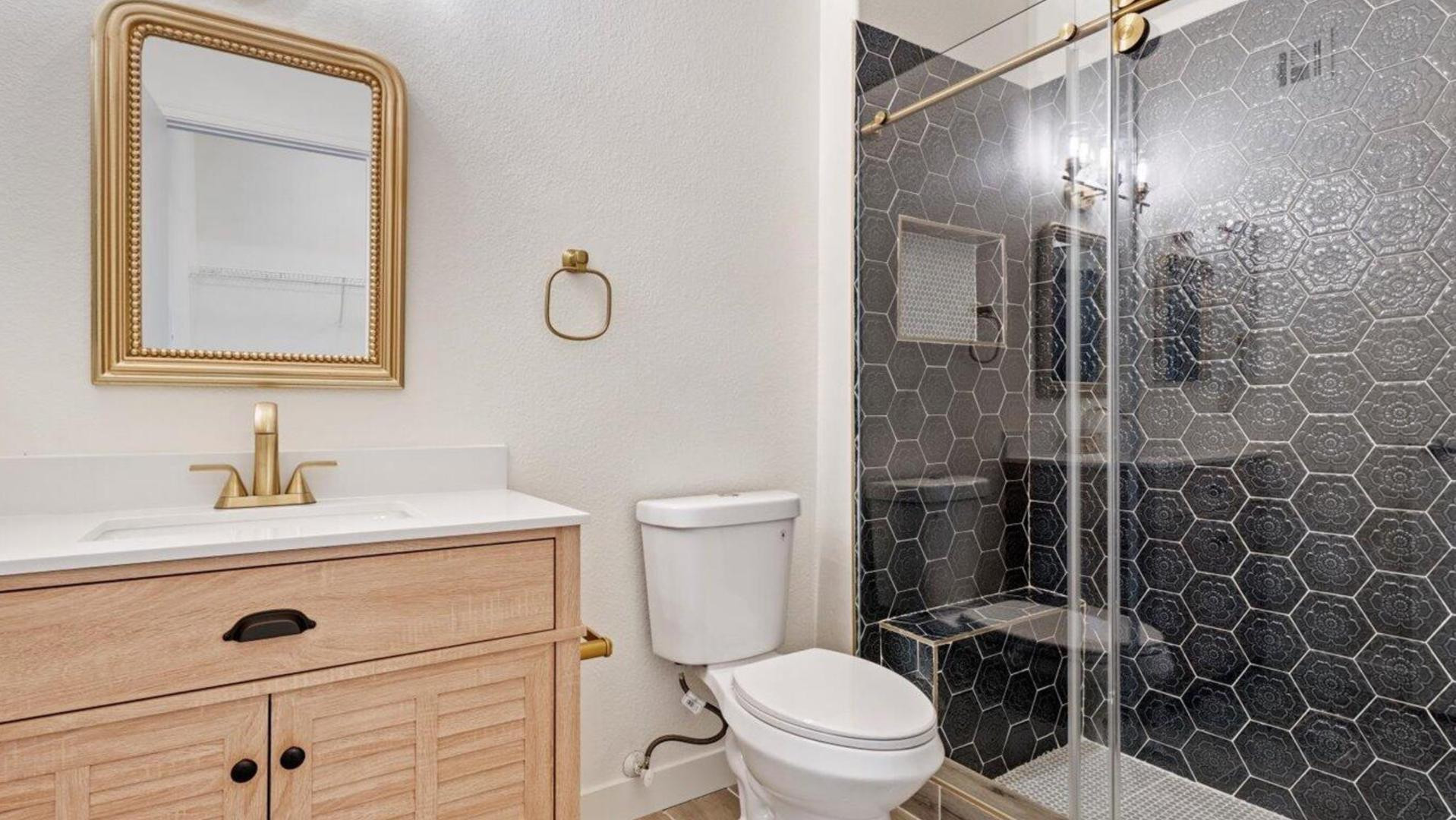 3434 East Baseline Road, Unit 260 Phoenix, AZ 85042 - Photo 2 of 19 a bathroom with a toilet sink vanity and mirror