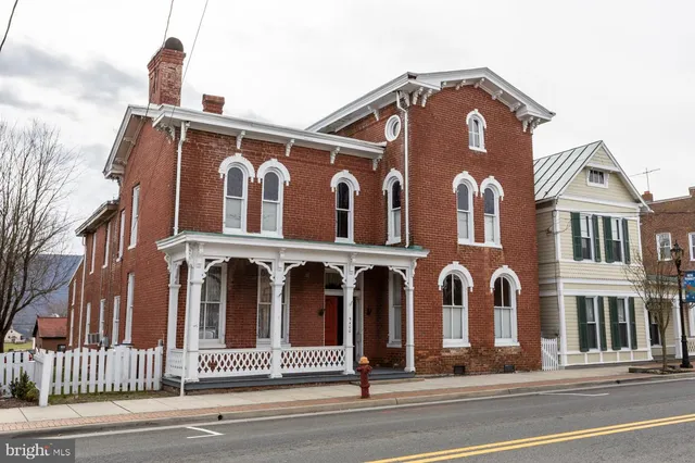 front view of a brick house with a ceiling fan