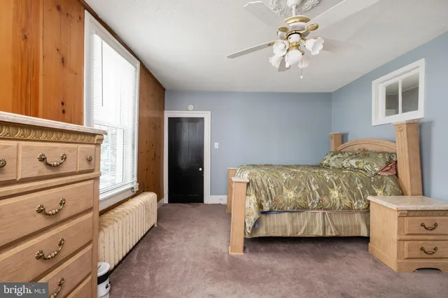 a bathroom with a toilet sink a mirror and vanity