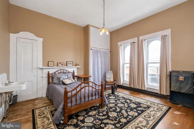 a bedroom with a bed and with furniture