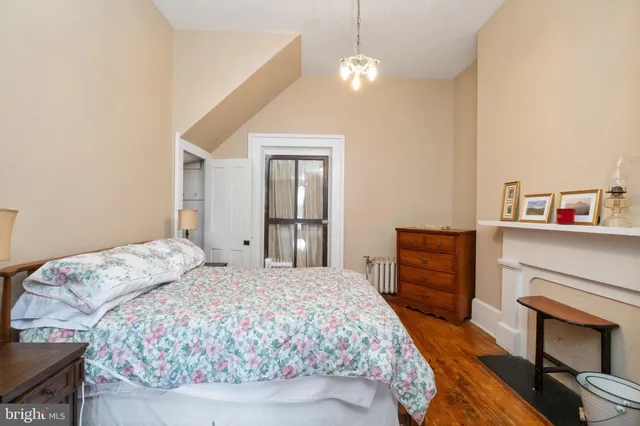 a bedroom with a bed and a fireplace