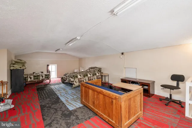 a view of staircase with railing and a chandelier