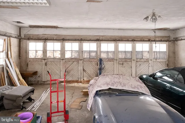 a view of a house with a yard patio and fire pit