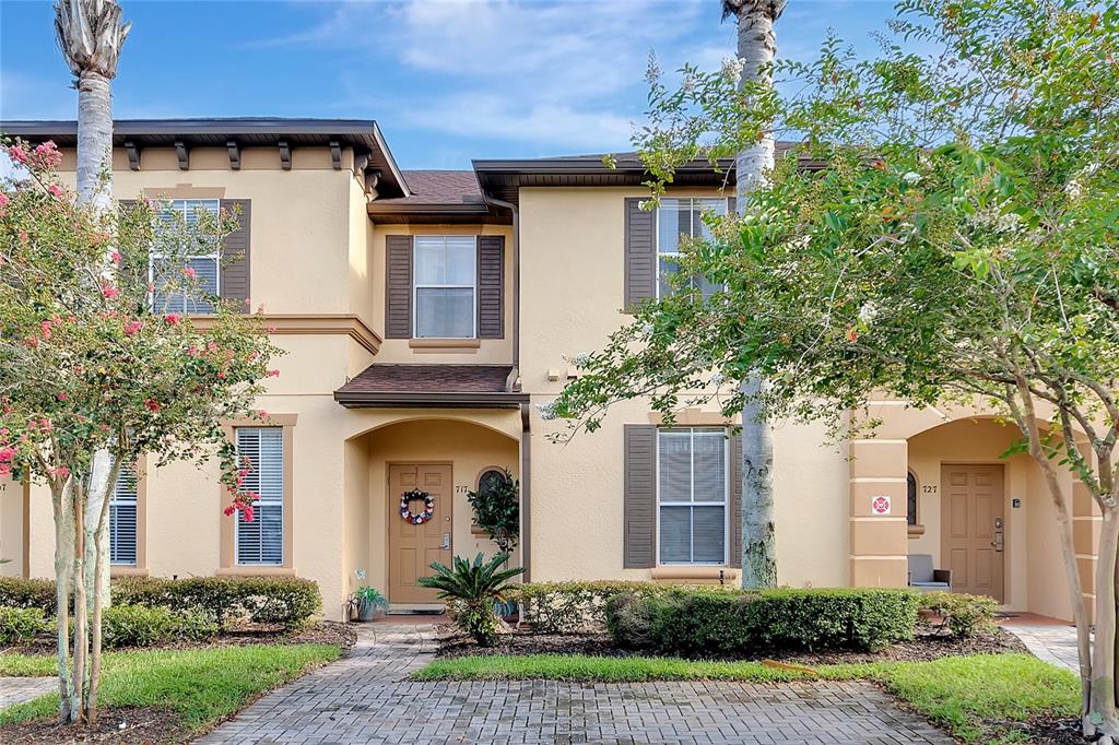717 Terra Lago Street, Unit 717 Davenport, FL 33897 - Photo 1 of 49 a front view of a house with garden