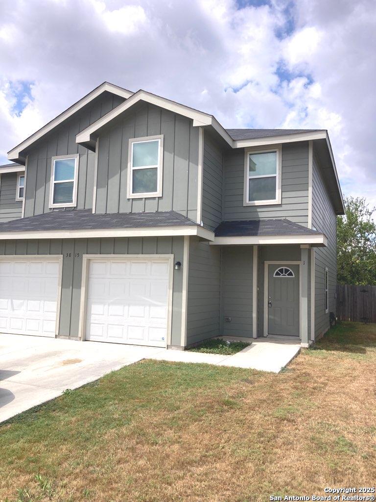 a front view of a house with a yard and garage