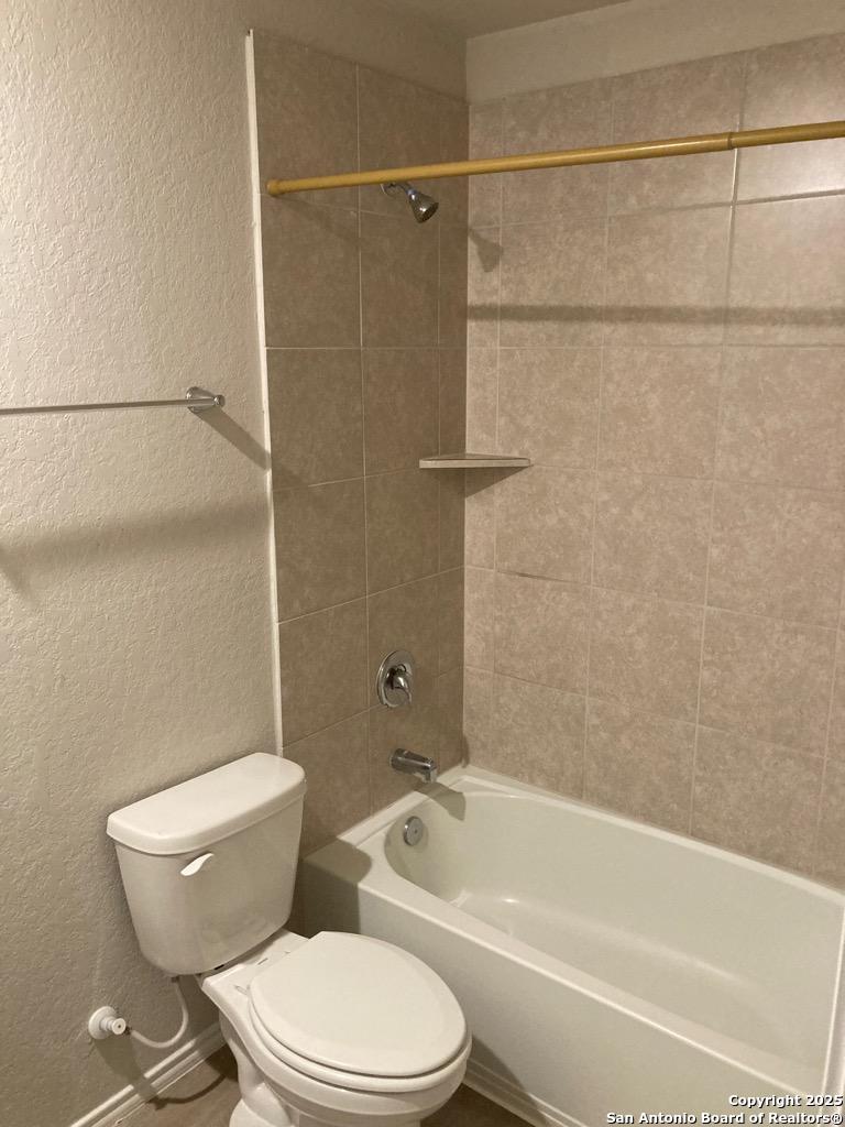 3815 Key W Way, Unit 1 Converse, TX 78109 - Photo 9 of 11 a white toilet and tub sitting next to a bathroom sink