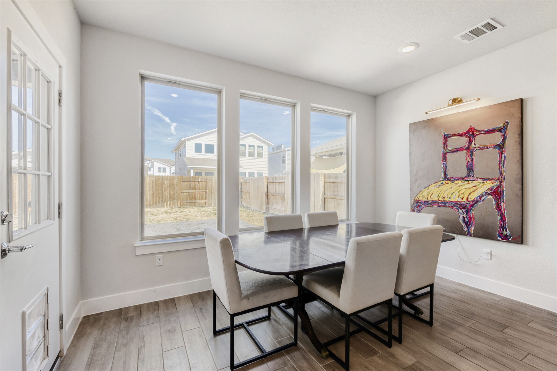 8602 Cottage Rose Drive Austin, TX 78744 - Photo 11 of 17 Dining space with wood finished floors and baseboards