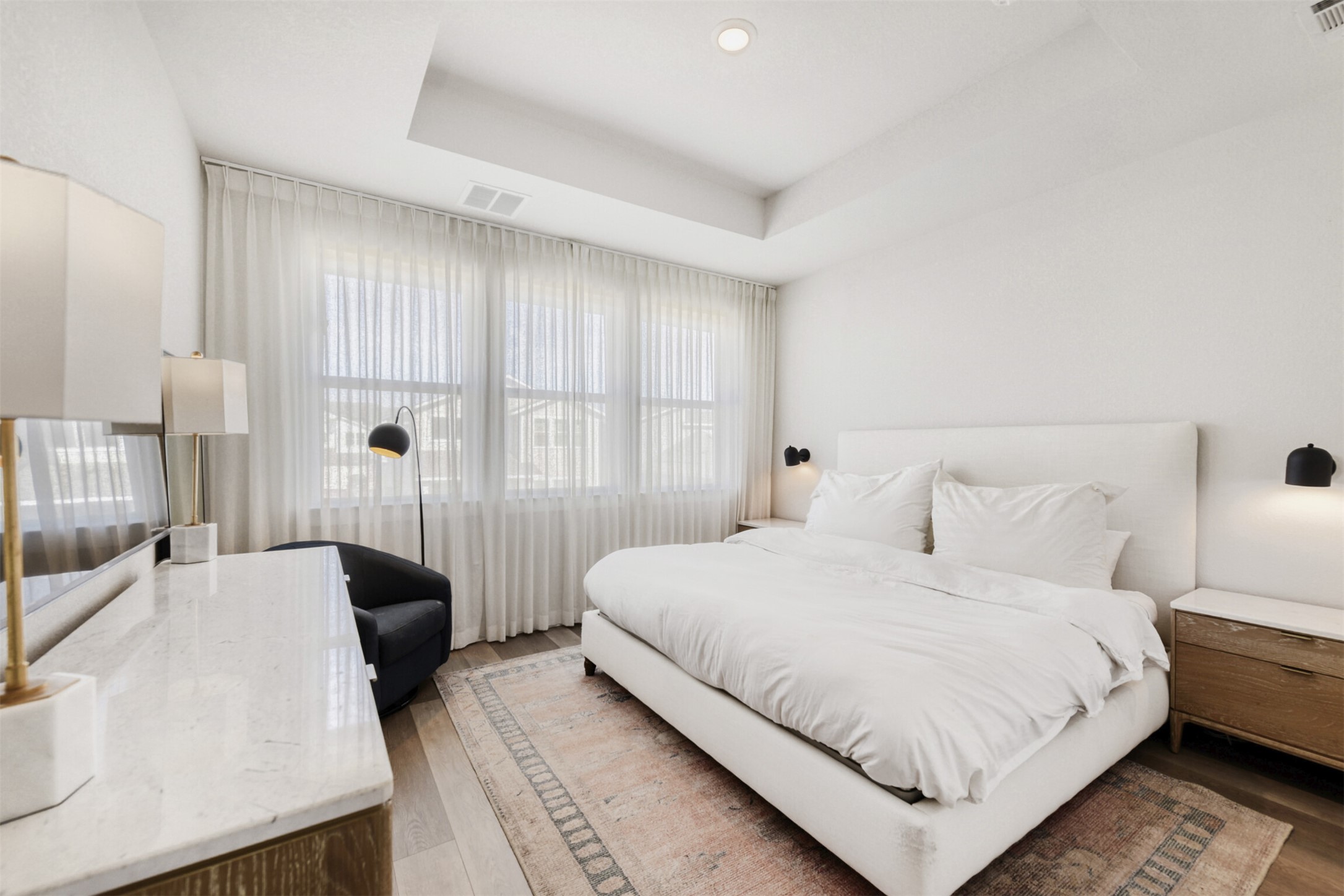 8602 Cottage Rose Drive Austin, TX 78744 - Photo 13 of 17 Bedroom featuring a raised ceiling and light wood finished floors