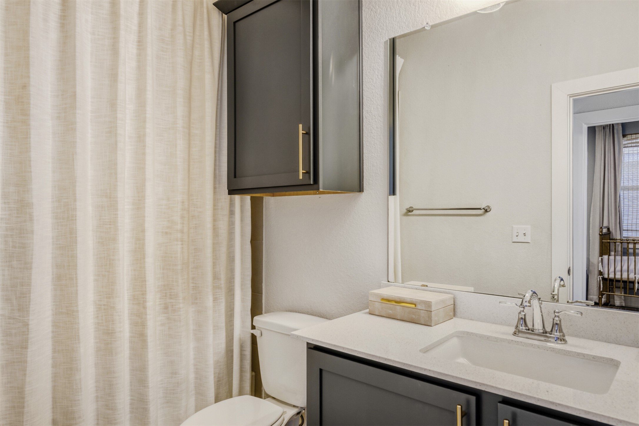 8602 Cottage Rose Drive Austin, TX 78744 - Photo 16 of 17 Full bath with vanity, curtained shower, and a textured wall