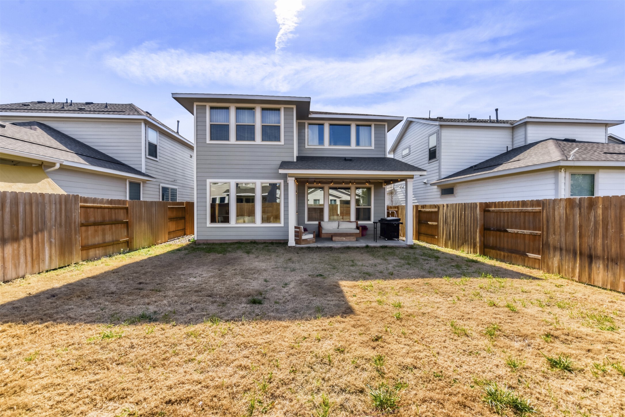 8602 Cottage Rose Drive Austin, TX 78744 - Photo 4 of 17 Rear view of house featuring a patio area and a fenced backyard