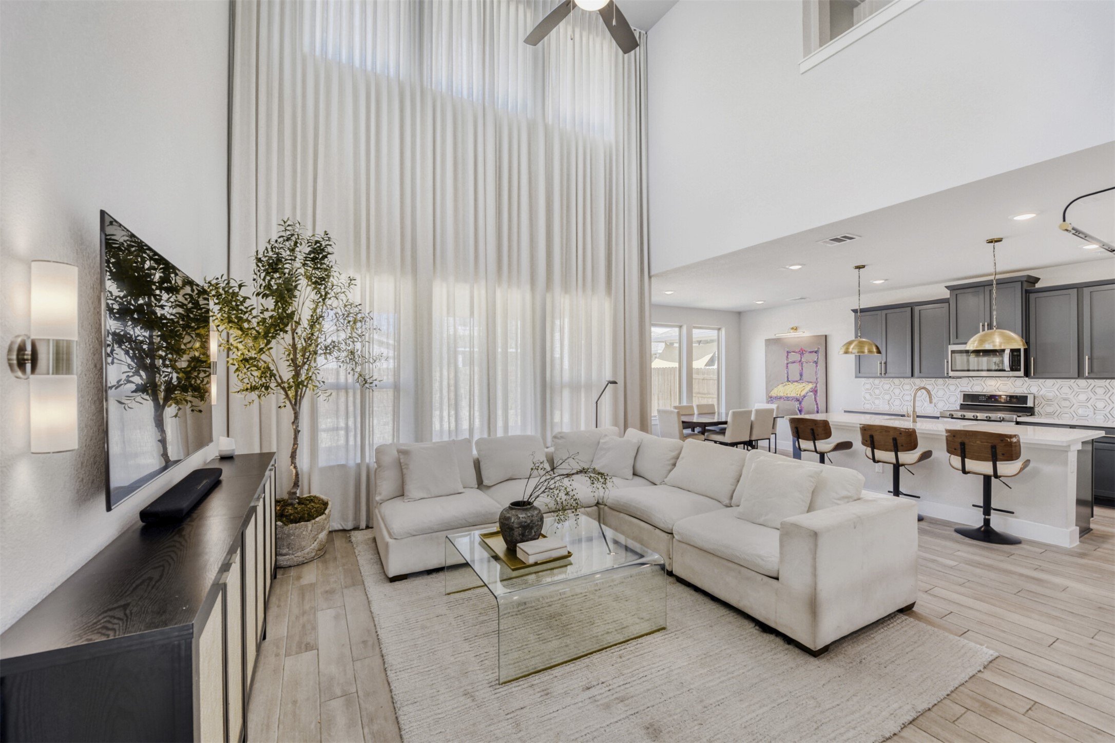 8602 Cottage Rose Drive Austin, TX 78744 - Photo 5 of 17 Living area featuring a high ceiling, a ceiling fan, and light wood-style flooring