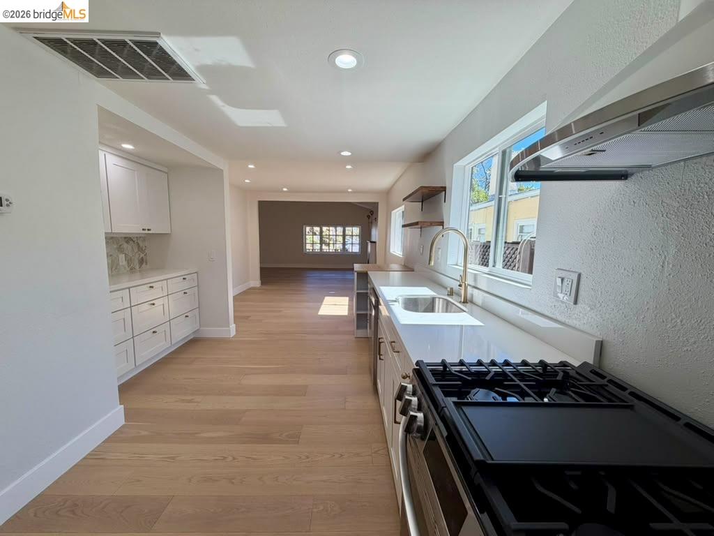 1327 Ward Street Berkeley, CA 94702 - Photo 5 of 8 a kitchen with stainless steel appliances granite countertop a stove and a sink