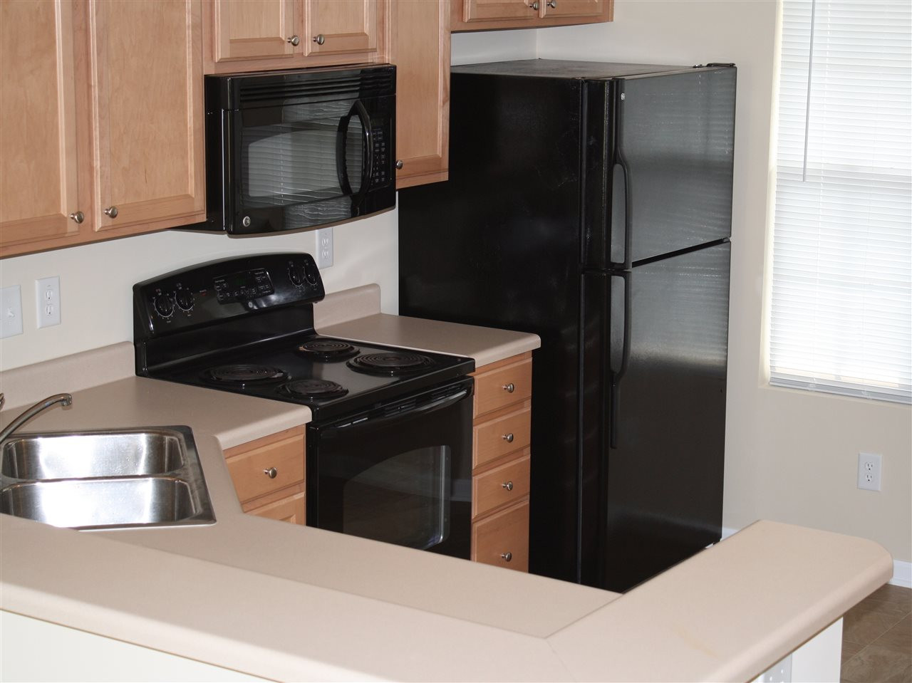 8007 River Water Court Raleigh, NC 27616 - Photo 3 of 10 a kitchen with a refrigerator stove and microwave