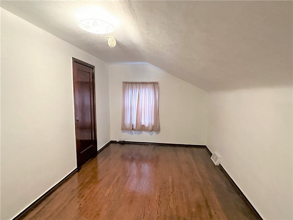 89 Thomas Street Crafton, PA 15205 - Photo 7 of 13 an empty room with wooden floor and windows