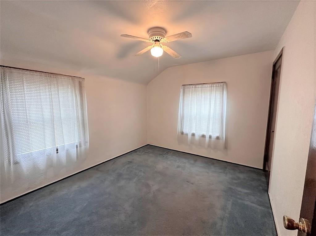 89 Thomas Street Crafton, PA 15205 - Photo 8 of 13 an empty room with chandelier fan and windows