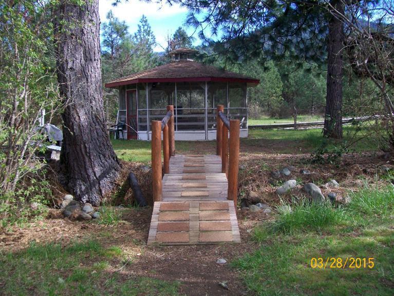 5015 Waldo Road Cave Junction, OR 97523 - Photo 24 of 35 a front view of a house with garden
