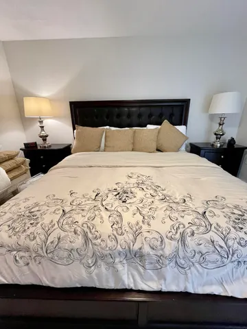 a bedroom with a bed and a lamp