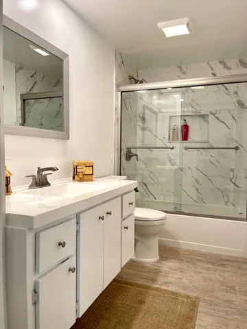 a bathroom with a sink toilet and shower