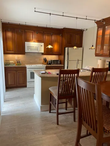 a kitchen with stainless steel appliances a stove a sink dishwasher and a refrigerator