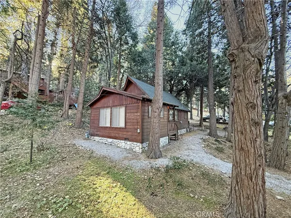 a view of wooden house with a small deck