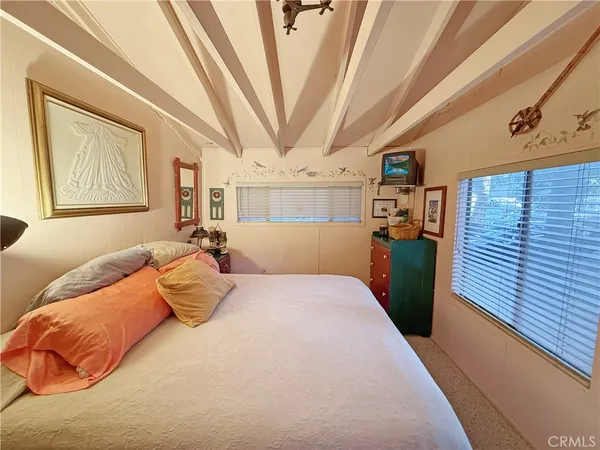 a bedroom with a bed and a mirror