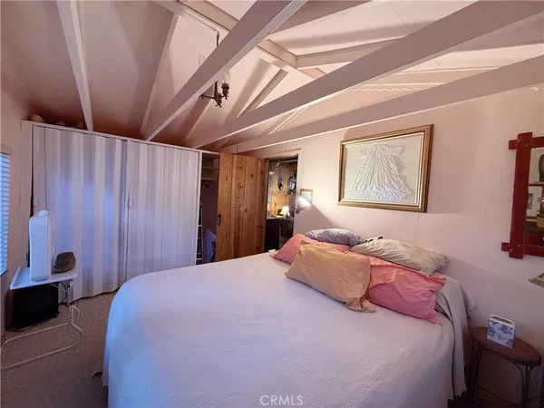 a bedroom with a bed and a large window