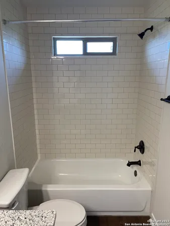 a bathroom with a toilet a sink and bathtub