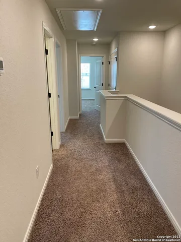 an empty room with a cabinet and mirror